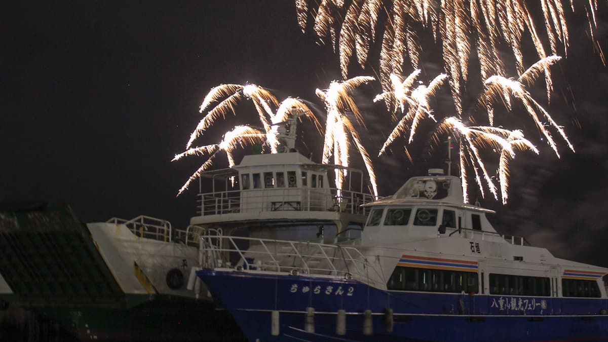 fireworks above two boats
